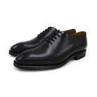 A black Berwick 1707 Wholecut Oxford shoe made from box calf leather with a lace-up closure and a round toe.