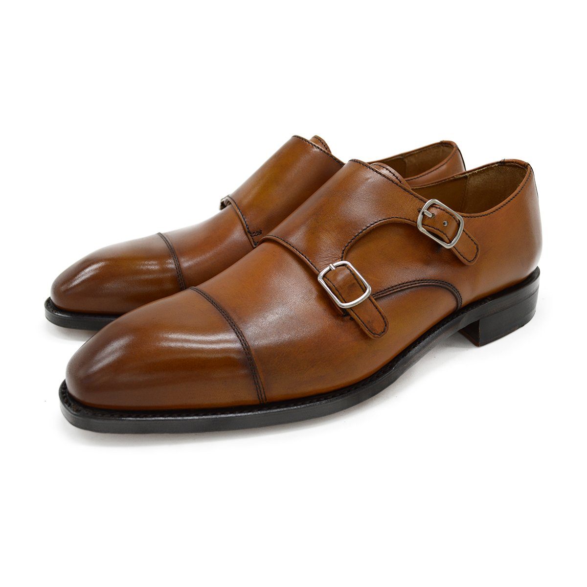 A brown double monk strap shoe with a polished leather upper and a Goodyear welted sole.