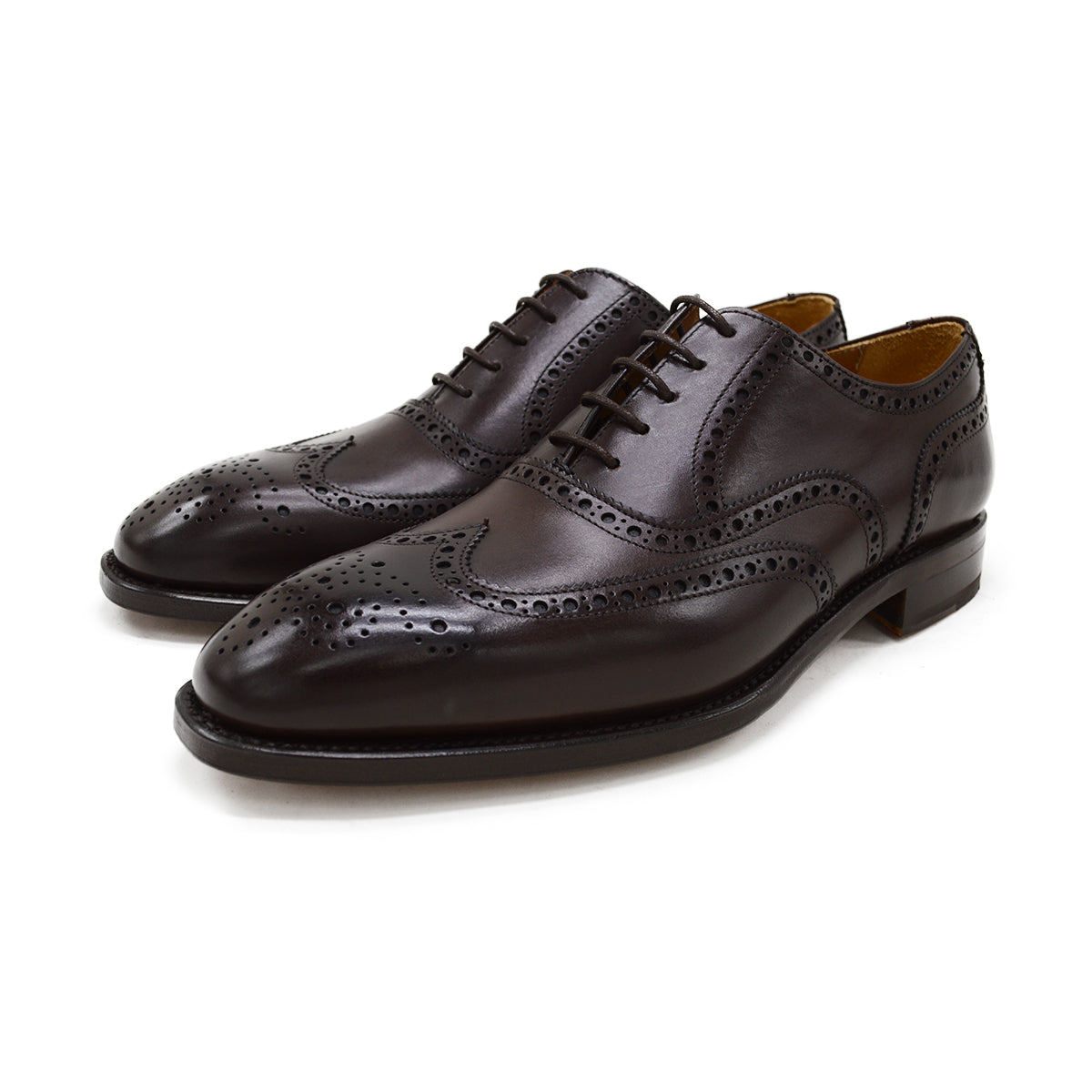 A dark brown Oxford brogue shoe with intricate brogue detailing and a goodyear welted leather sole.