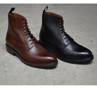 A Berwick 1707 brown & black grain toe cap boot with a full lace-up construction and a round toe shape, set against a polished concrete background.