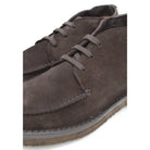 A brown Berwick 1707 apron boot with lace-up closure, handcrafted from reverse kudu suede, featuring moccasin stitching and a crepe rubber sole.