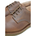 A dark chestnut brown Astorflex Redflex derby shoe made of nubuck leather, featuring a natural crepe rubber sole.