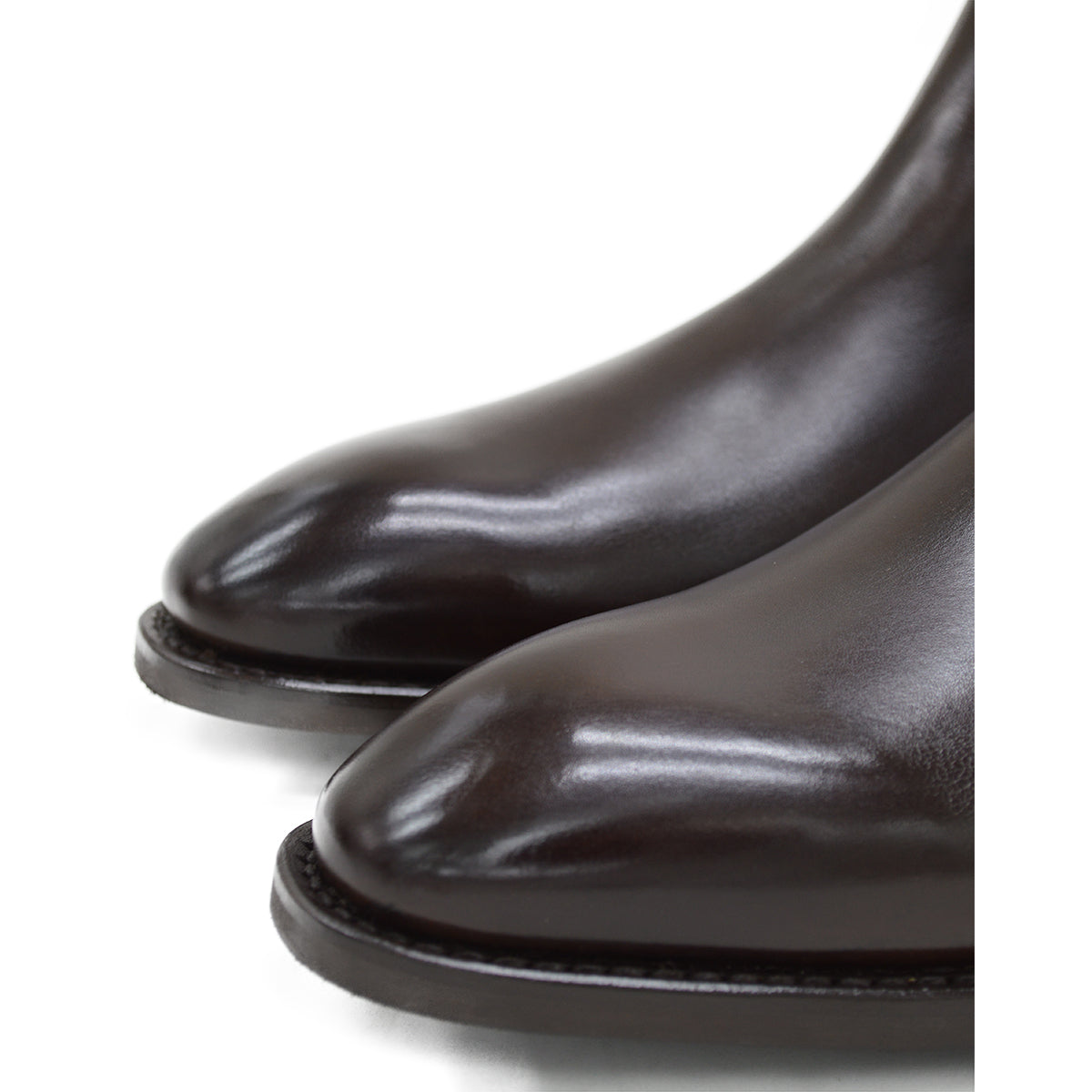 A dark brown leather Chelsea boot with a side pull tab and a low heel & Dainite soles, displayed on a white background.