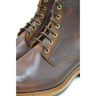 A brown leather service boot with a dainite sole and brass eyelets, designed for the forestry industry.