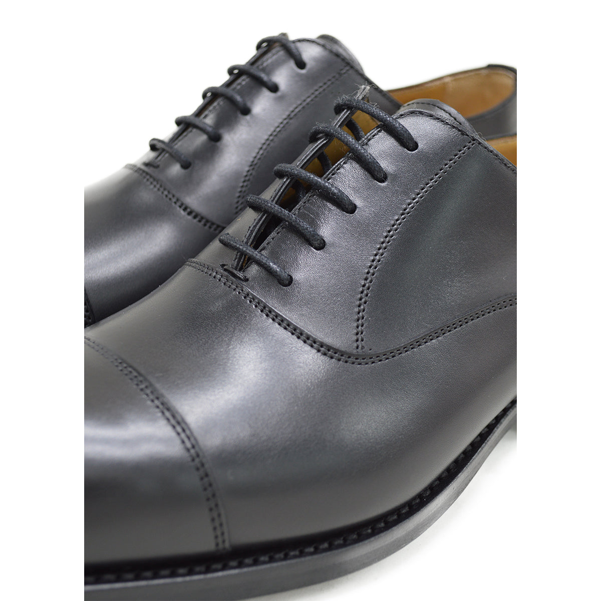 A Berwick 1707 black leather Oxford shoe with a chisel toe and lace-up closure with a Dainite rubber studded sole, on a white background.