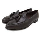 A Berwick 1707 dark brown deerskin Belgian loafer with a tassel detail on the vamp, displayed on a white background.