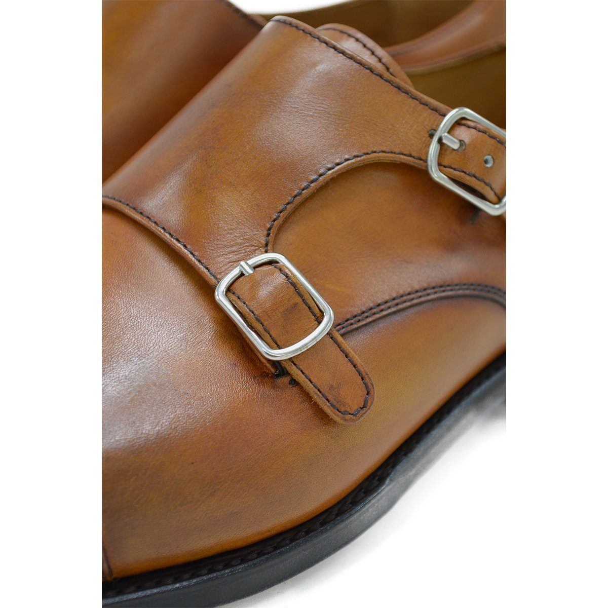 A brown double monk strap shoe with a polished leather upper and a Goodyear welted sole.