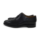 A Berwick 1707 black Oxford shoe with a polished, smooth upper and a Dainite rubber sole.