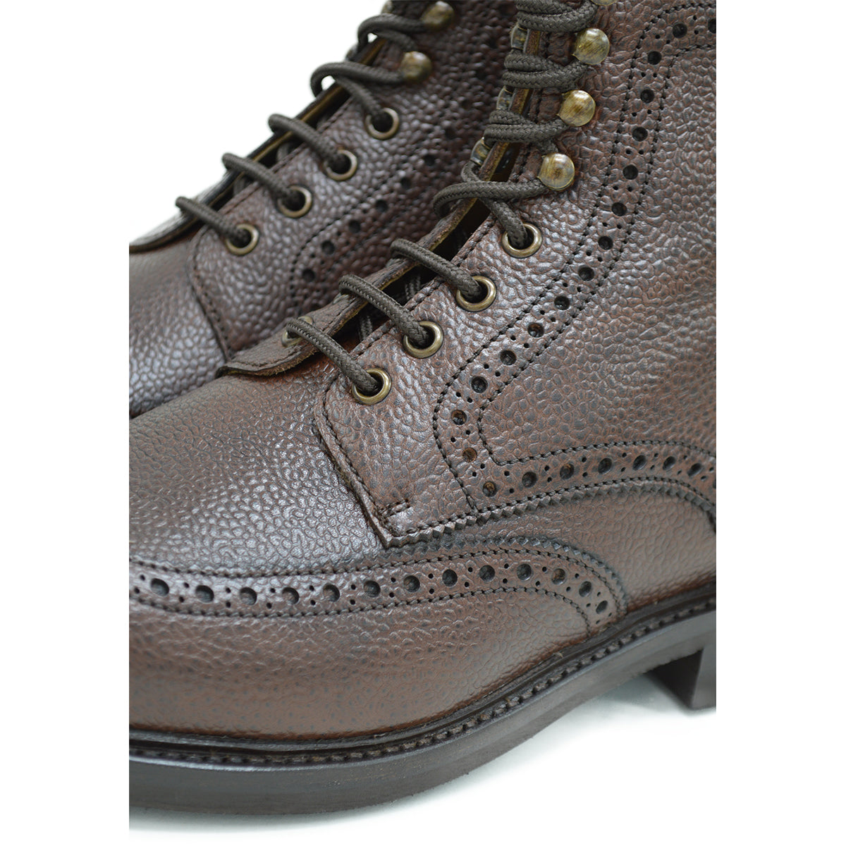 A Berwick 1707 dark brown brogue boot with a lace-up closure, round toe shape, and a Dainite rubber sole.