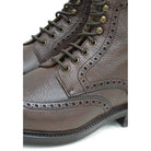 A Berwick 1707 dark brown brogue boot with a lace-up closure, round toe shape, and a Dainite rubber sole.