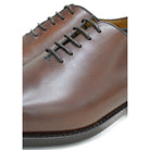 A Berwick 1707 brown leather wholecut oxford shoe with a lace-up closure and a round toe.