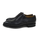 A Berwick 1707 black leather Oxford shoe with a chisel toe and lace-up closure with a Dainite rubber studded sole, on a white background.