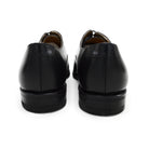 A Berwick 1707 black Oxford shoe with a polished, smooth upper and a Dainite rubber sole.