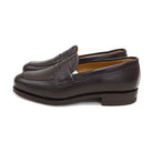 A dark brown deerskin penny loafer with a velvety soft texture and a classic round toe shape on a white background with Dainite Studded Rubber Sole.