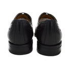 A black wholecut Oxford brogue shoe with a brogue pattern on the upper, a lace-up closure, and a goodyear welted leather sole.