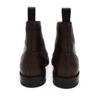 A Berwick 1707 dark brown brogue boot with a lace-up closure, round toe shape, and a Dainite rubber sole.
