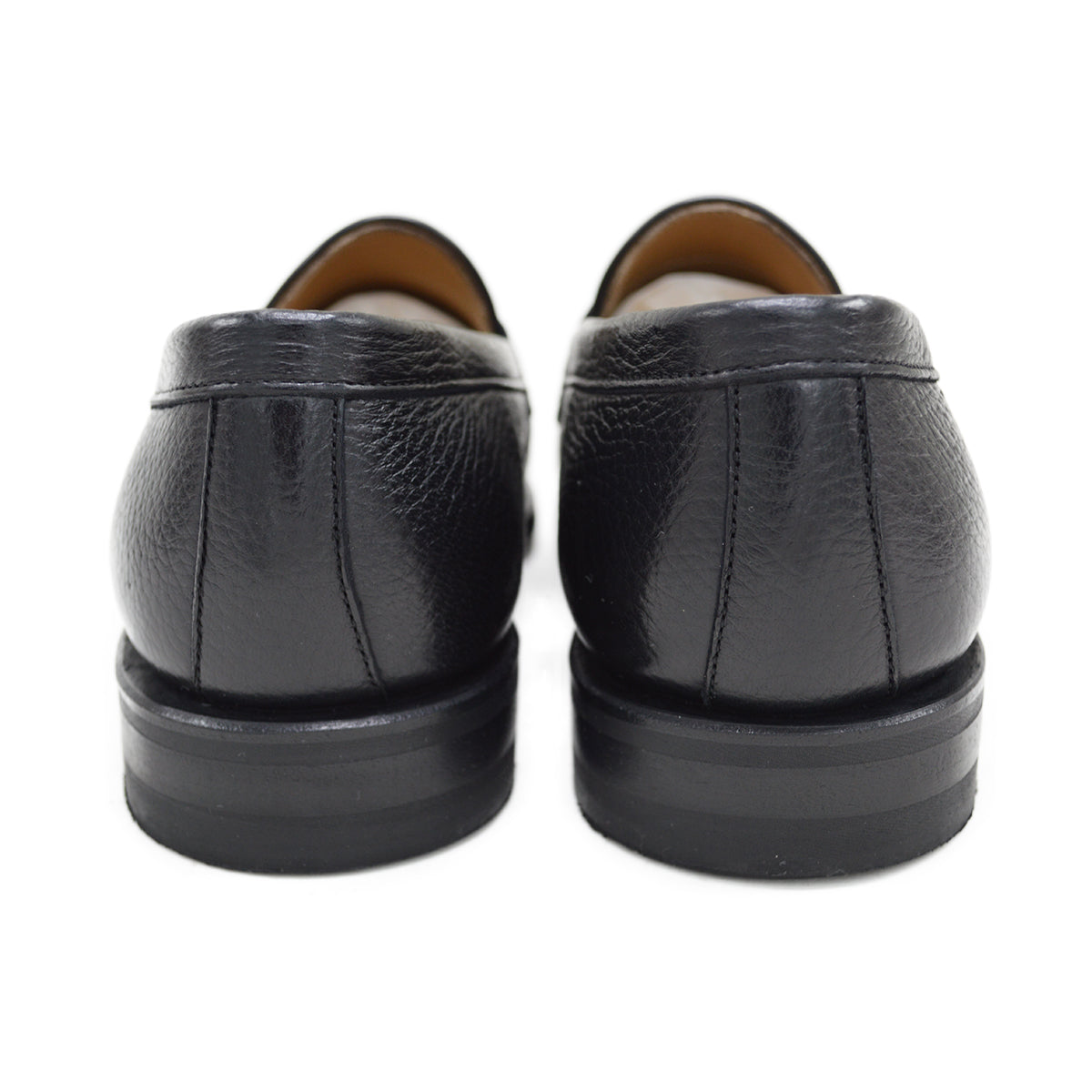 A black deerskin Penny loafer with a velvety soft texture and a classic round toe & Dainite sole, set against a white background.