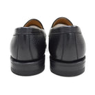 A black deerskin Penny loafer with a velvety soft texture and a classic round toe & Dainite sole, set against a white background.