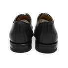 A Berwick 1707 black leather Oxford shoe with a chisel toe and lace-up closure with a Dainite rubber studded sole, on a white background.