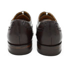 A dark brown Oxford brogue shoe with intricate brogue detailing and a goodyear welted leather sole.