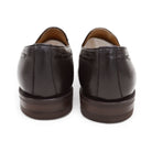 A Berwick 1707 dark brown deerskin slip-on loafer with a tassel detail on the vamp & Dainite sole, displayed on a plain background