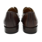 A Berwick 1707 dark brown, chisel toe Oxford shoe with a lace-up closure and a single leather sole.