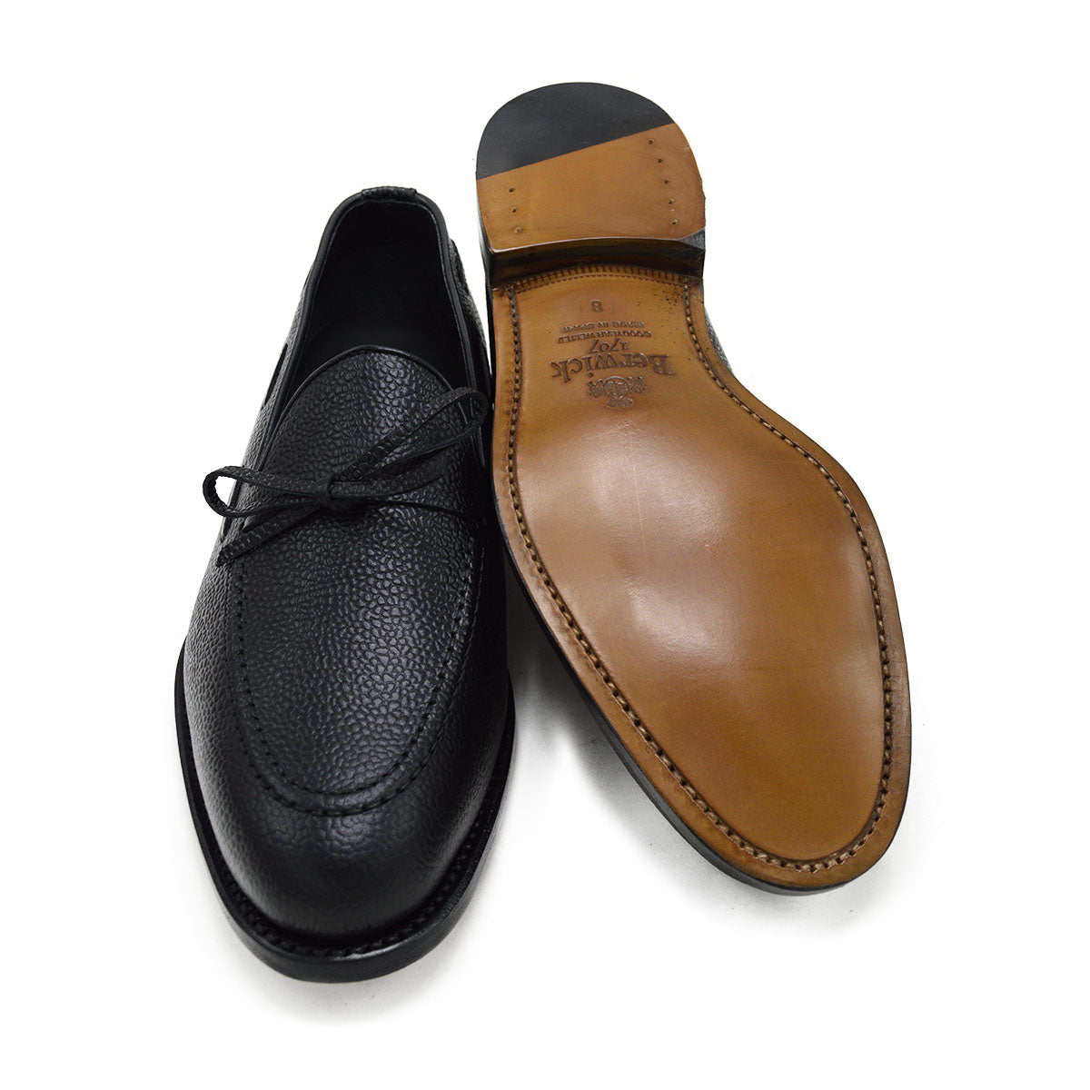 A Berwick 1707 classic black unlined laced slip-on loafer with a Goodyear welted leather sole.