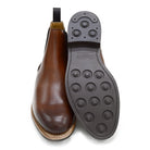 A brown Berwick 1707 Chelsea Boot with a pull tab on the side, showcasing a traditional round-toe shape and a natural welt with a Dainite rubber sole.