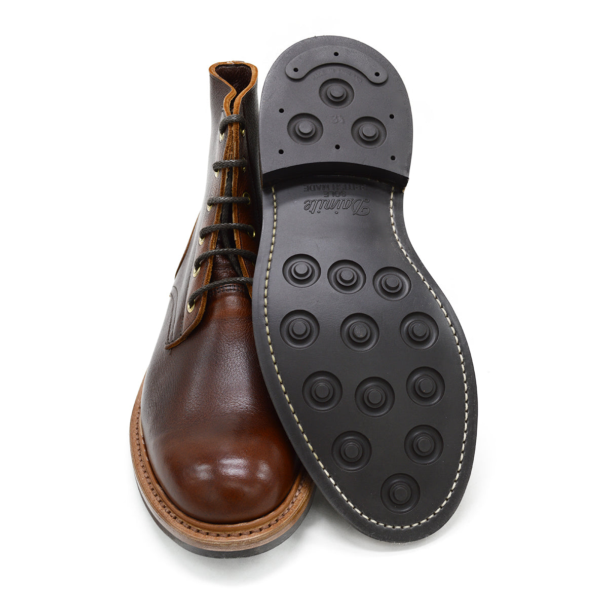A brown leather service boot with a dainite sole and brass eyelets, designed for the forestry industry.