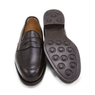 A dark brown deerskin penny loafer with a velvety soft texture and a classic round toe shape on a white background with Dainite Studded Rubber Sole.