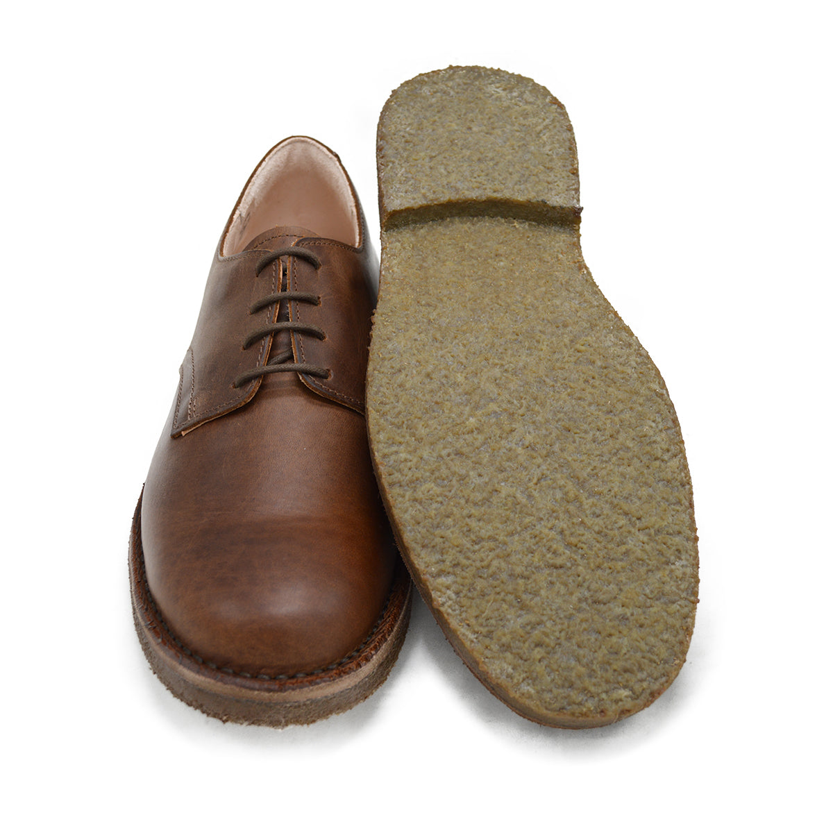 A dark chestnut brown Astorflex Redflex derby shoe made of nubuck leather, featuring a natural crepe rubber sole.