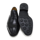 A Berwick 1707 black leather Oxford shoe with a chisel toe and lace-up closure with a Dainite rubber studded sole, on a white background.