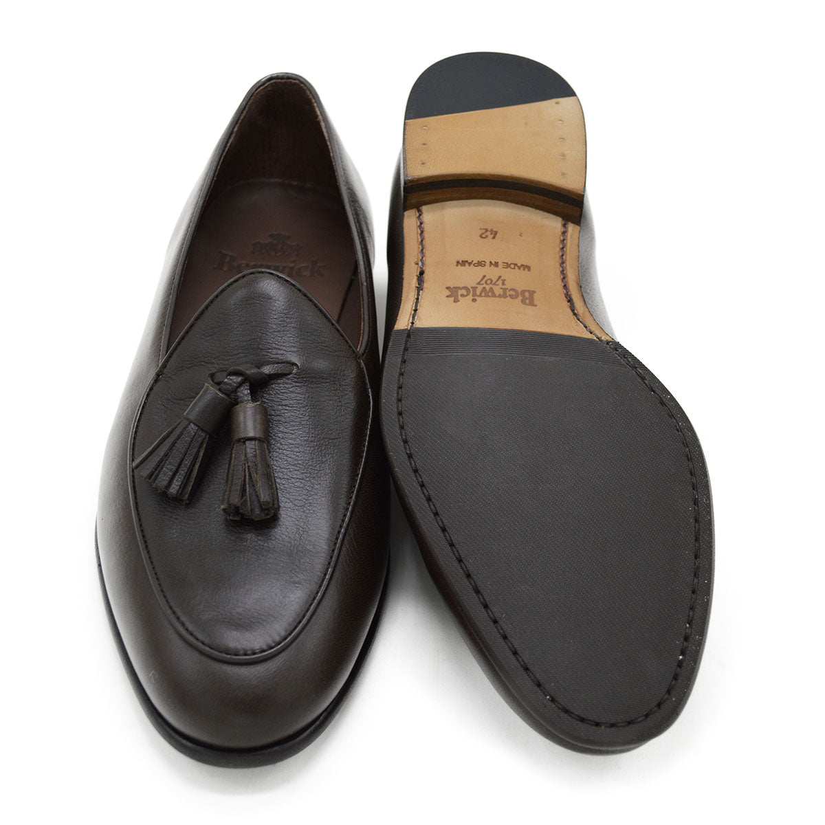 A Berwick 1707 dark brown deerskin Belgian loafer with a tassel detail on the vamp, displayed on a white background.