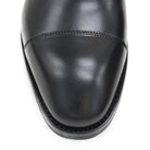 A Berwick 1707 black leather Oxford shoe with a chisel toe and lace-up closure with a Dainite rubber studded sole, on a white background.