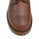 A dark chestnut brown Astorflex Redflex derby shoe made of nubuck leather, featuring a natural crepe rubber sole.