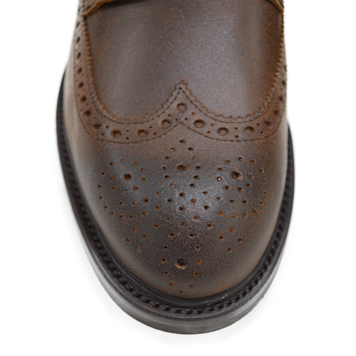A dark brown lace-up brogue boot with a rubber sole and visible stitching on the upper part.