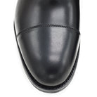 A Berwick 1707 black Oxford shoe with a polished, smooth upper and a Dainite rubber sole.