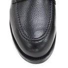 A black deerskin Penny loafer with a velvety soft texture and a classic round toe & Dainite sole, set against a white background.