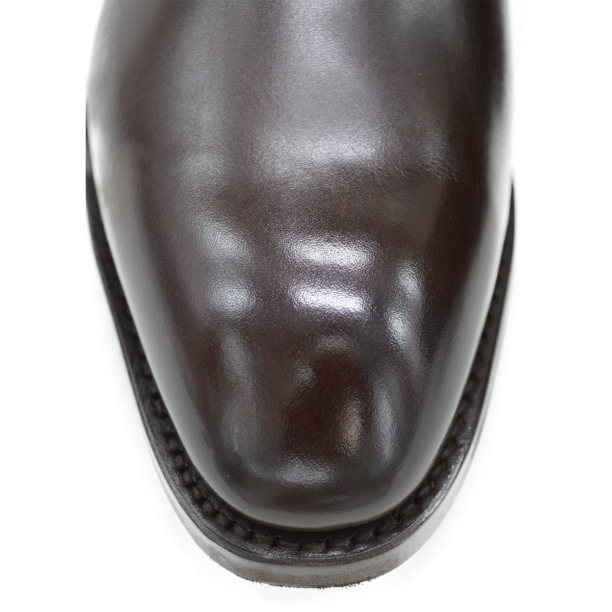 A dark brown leather Chelsea boot with a side pull tab and a low heel & Dainite soles, displayed on a white background.