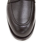 A dark brown deerskin penny loafer with a velvety soft texture and a classic round toe shape on a white background with Dainite Studded Rubber Sole.