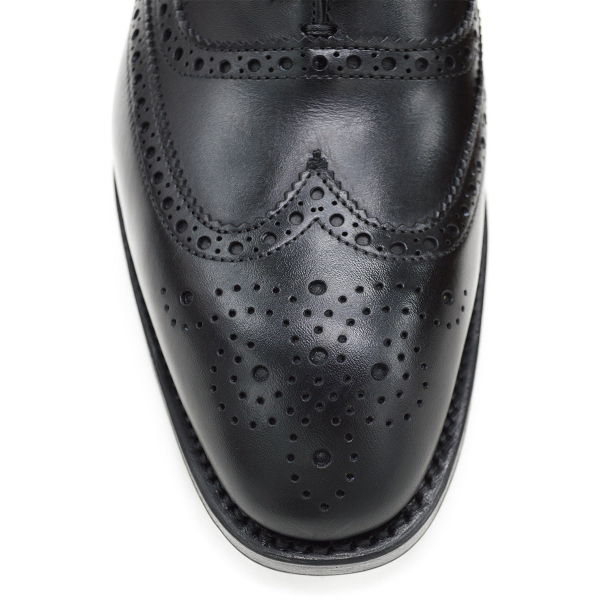 A Berwick 1707 black Oxford brogue shoe with brogue detailing and a lace-up closure. The shoe is made of smooth leather and appears to be sturdy and durable.