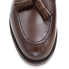 A Berwick 1707 brown tasseled loafer shoe with a closed toe and leather sole.