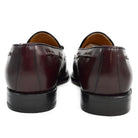A Berwick 1707 burgundy hi shine leather slip-on shoe with a tassel detail on the vamp, set against a white background.