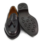 A Berwick 1707 dark brown tasselled slip-on shoe with a polished, smooth upper and a Dainite rubber sole.