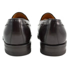 A Berwick 1707 dark brown tasselled slip-on shoe with a polished, smooth upper and a Dainite rubber sole.