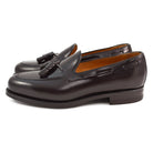 A Berwick 1707 dark brown tasselled slip-on shoe with a polished, smooth upper and a Dainite rubber sole.