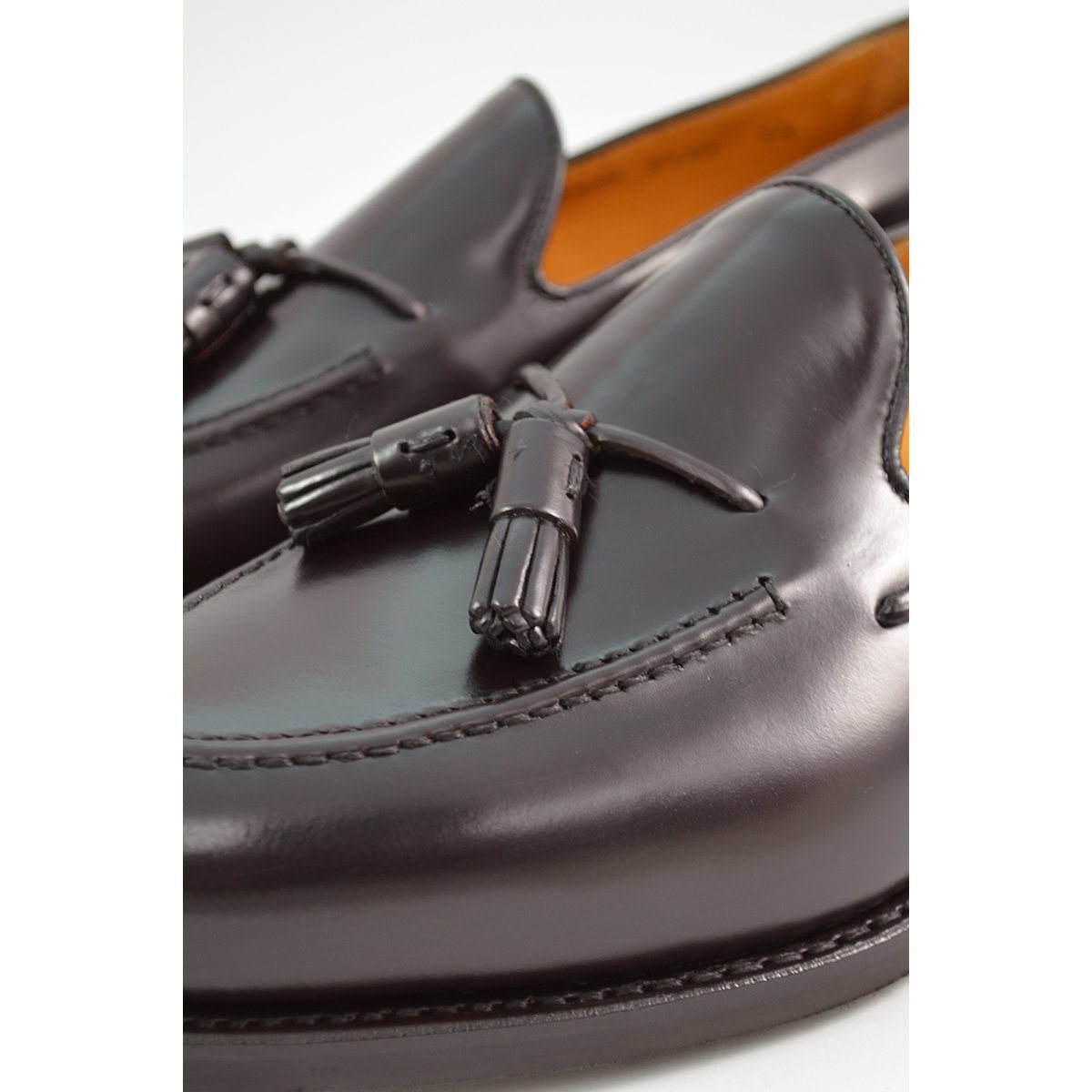 A Berwick 1707 dark brown tasselled slip-on shoe with a polished, smooth upper and a Dainite rubber sole.