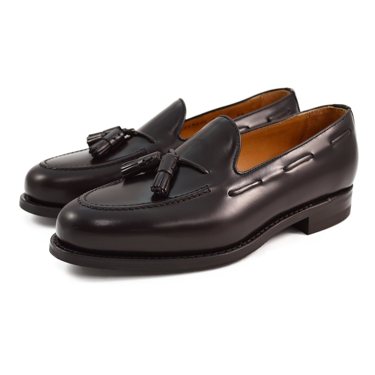 A Berwick 1707 dark brown tasselled slip-on shoe with a polished, smooth upper and a Dainite rubber sole.