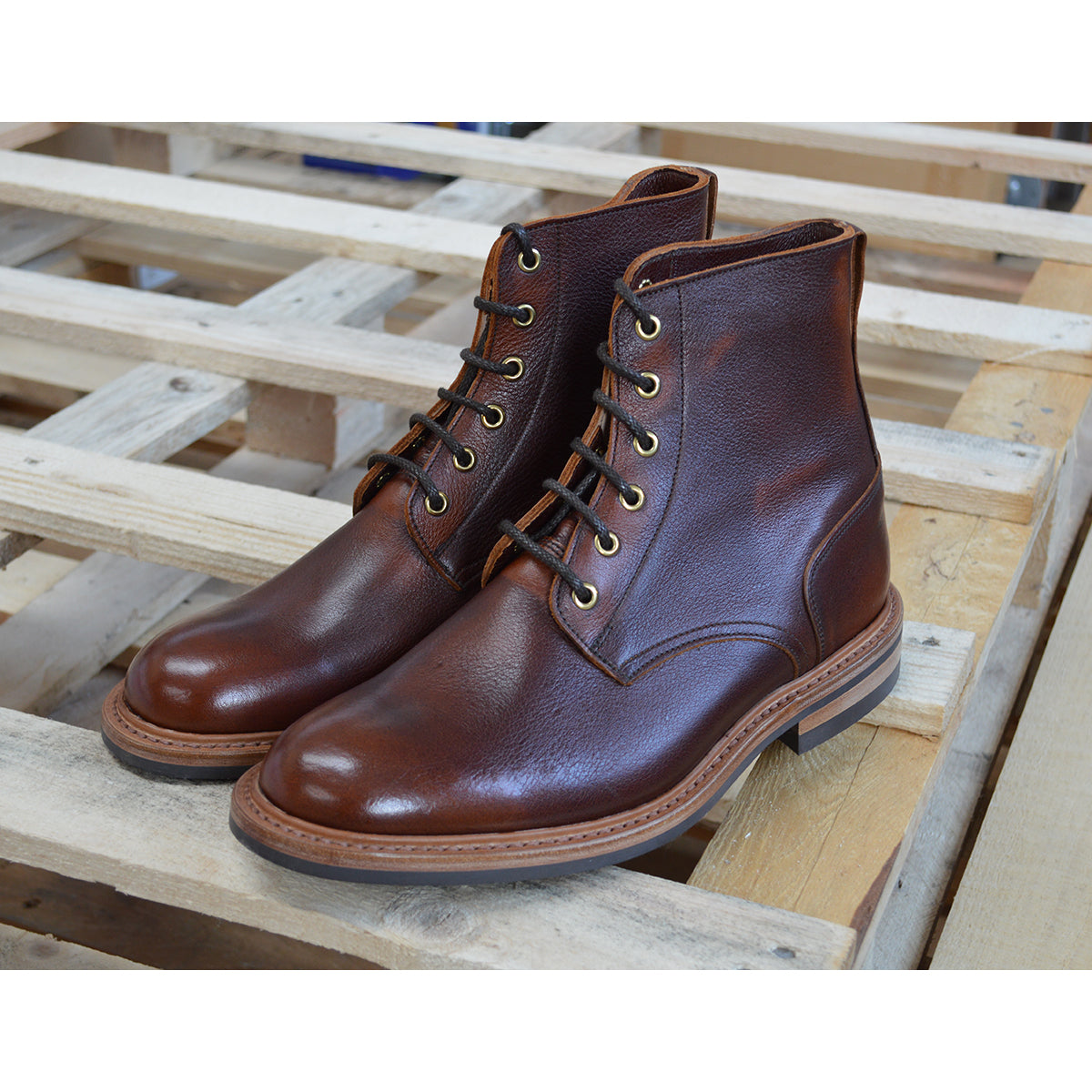 A brown leather service boot with a dainite sole and brass eyelets, designed for the forestry industry.