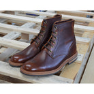 A brown leather service boot with a dainite sole and brass eyelets, designed for the forestry industry.